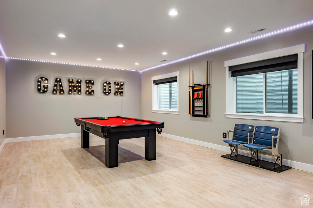 Recreation room with light hardwood / wood-style flooring and pool table