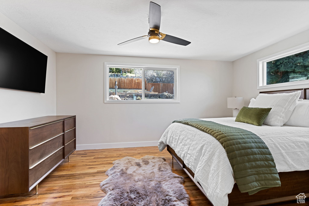 Bedroom with ceiling fan and wood-type flooring