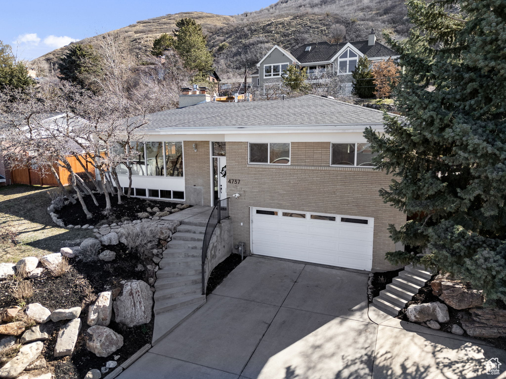 View of front of property featuring a mountain view and a garage