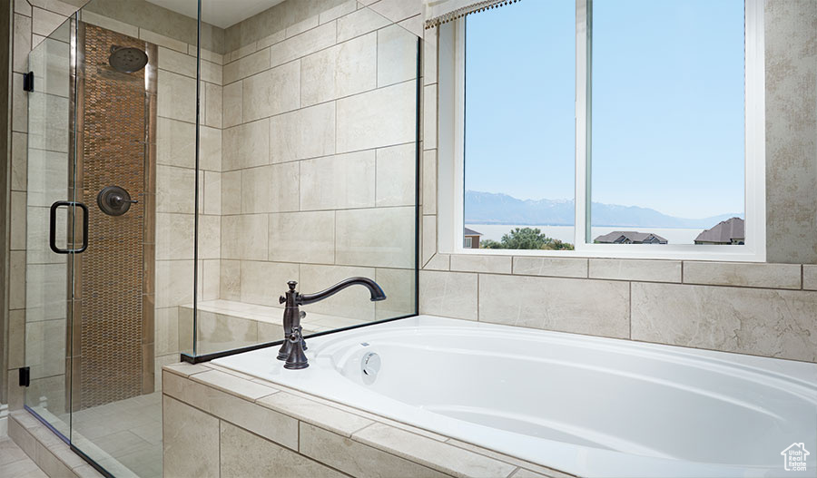 Bathroom featuring a mountain view and independent shower and bath