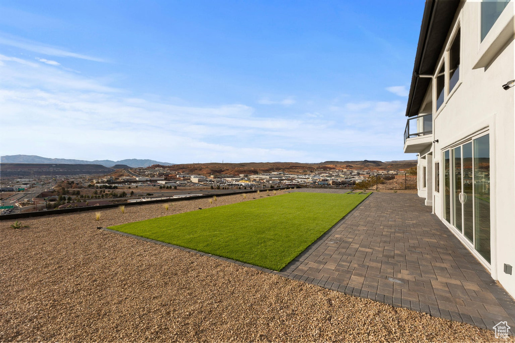 View of yard with a mountain view and a patio area