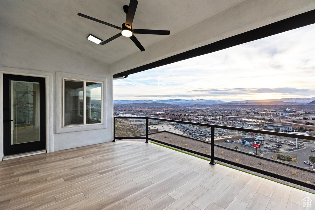 Balcony at dusk with a mountain view and ceiling fan