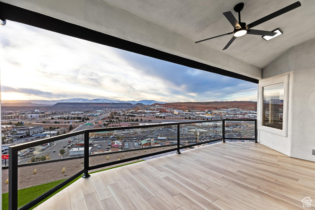 Balcony featuring a mountain view and ceiling fan