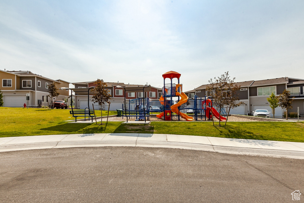 View of jungle gym featuring a lawn