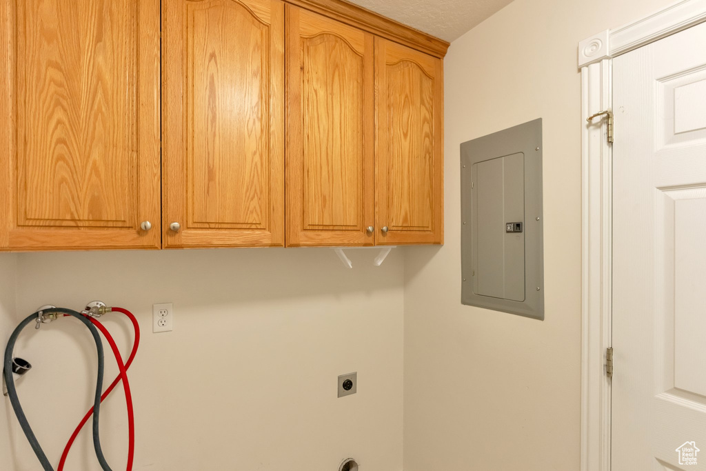 Washroom featuring washer hookup, hookup for an electric dryer, and cabinets