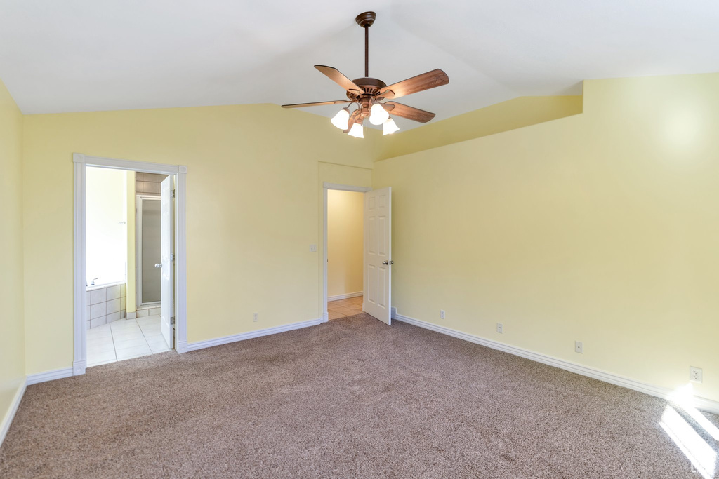 Unfurnished room with light carpet, lofted ceiling, and ceiling fan