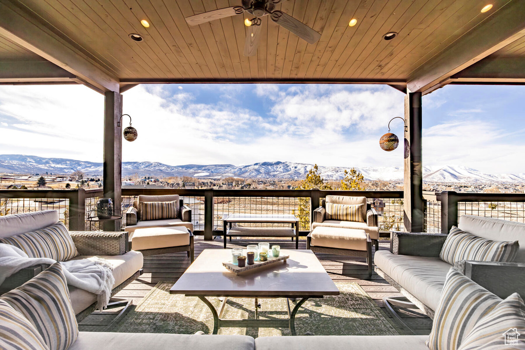 View of patio with an outdoor living space, a balcony, and a mountain view