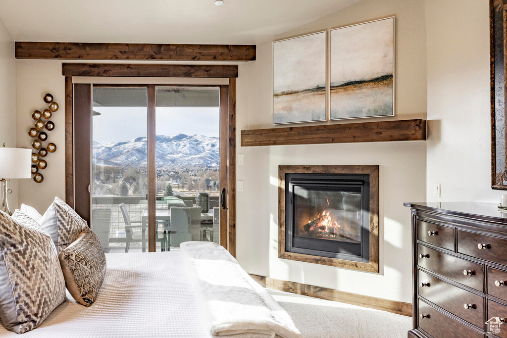 Bedroom with access to exterior and a mountain view