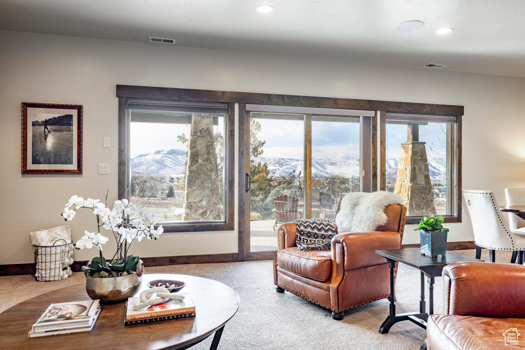 Living room featuring a mountain view and light colored carpet