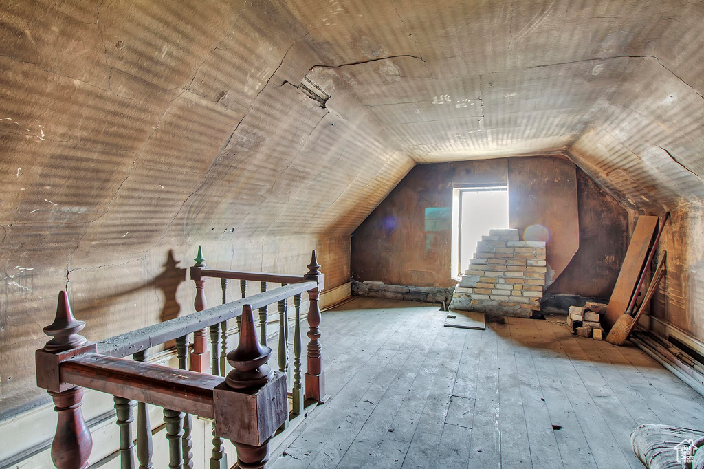 Bonus room with vaulted ceiling and light hardwood / wood-style floors