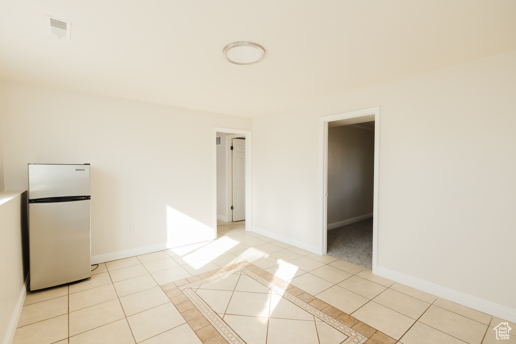 Spare room featuring light tile floors