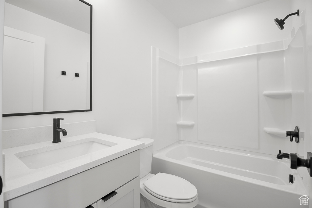 Full bathroom featuring bathtub / shower combination, toilet, and vanity