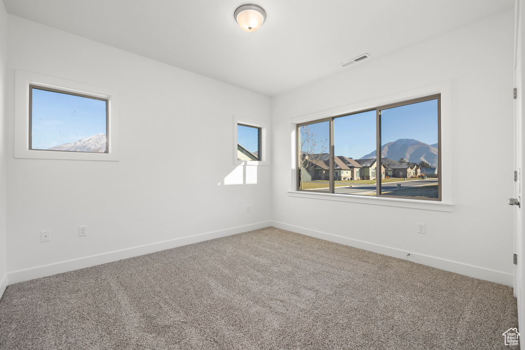 Carpeted spare room with a mountain view