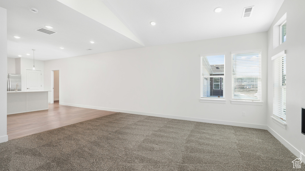 Unfurnished living room with light carpet