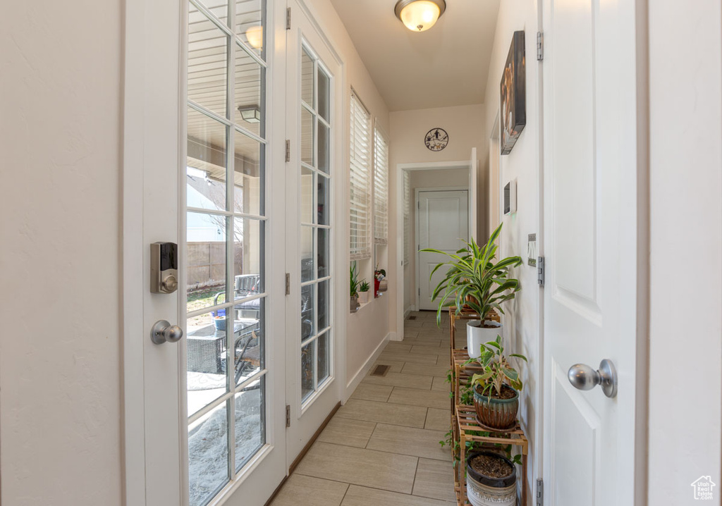 Entryway with light tile flooring and a healthy amount of sunlight