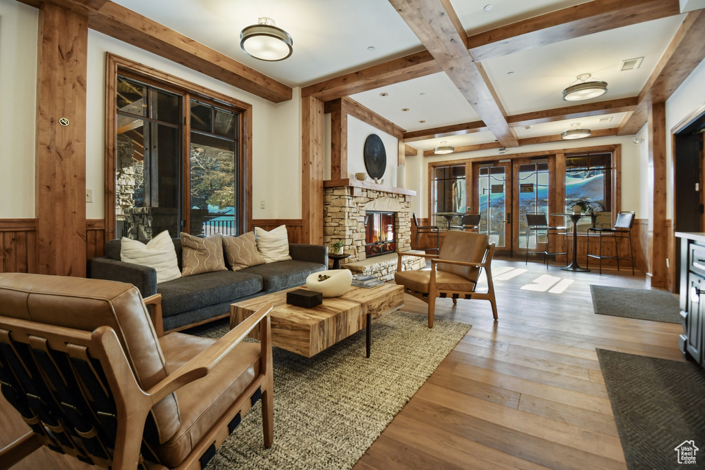 Interior space featuring plenty of natural light, a stone fireplace, and light hardwood / wood-style floors