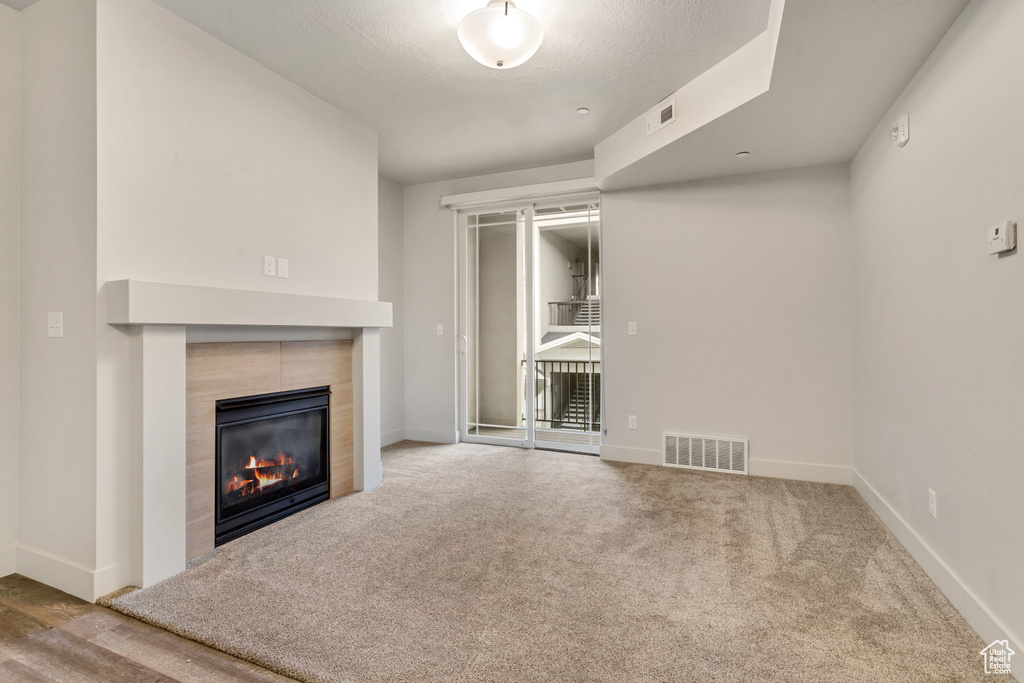 Unfurnished living room featuring a fireplace