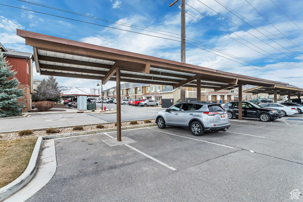 View of parking featuring a carport