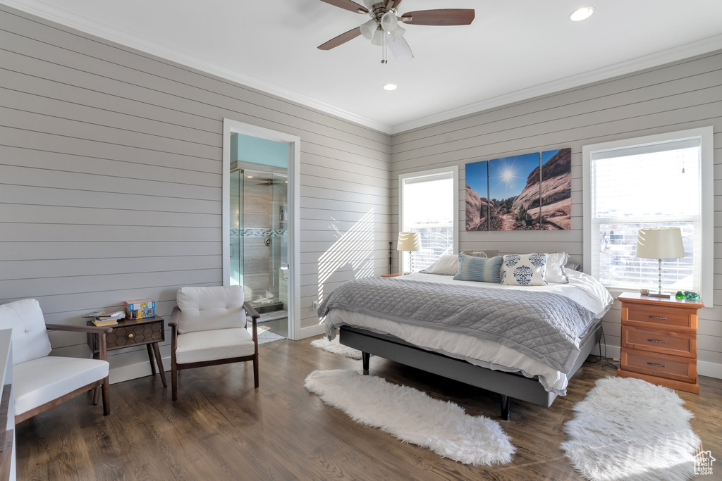 Bedroom with dark hardwood / wood-style flooring, ornamental molding, and ceiling fan