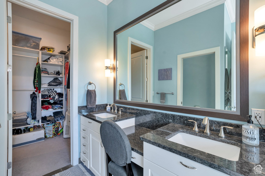 Bathroom featuring vanity and ornamental molding