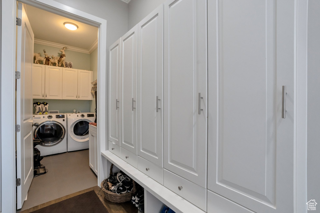 Laundry room with separate washer and dryer, tile floors, hookup for a washing machine, cabinets, and ornamental molding