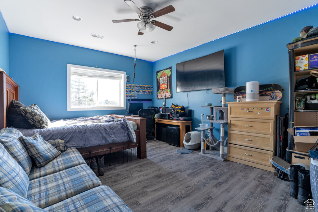 Bedroom featuring dark hardwood / wood-style floors and ceiling fan