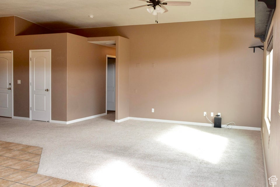Spare room with light tile flooring and ceiling fan