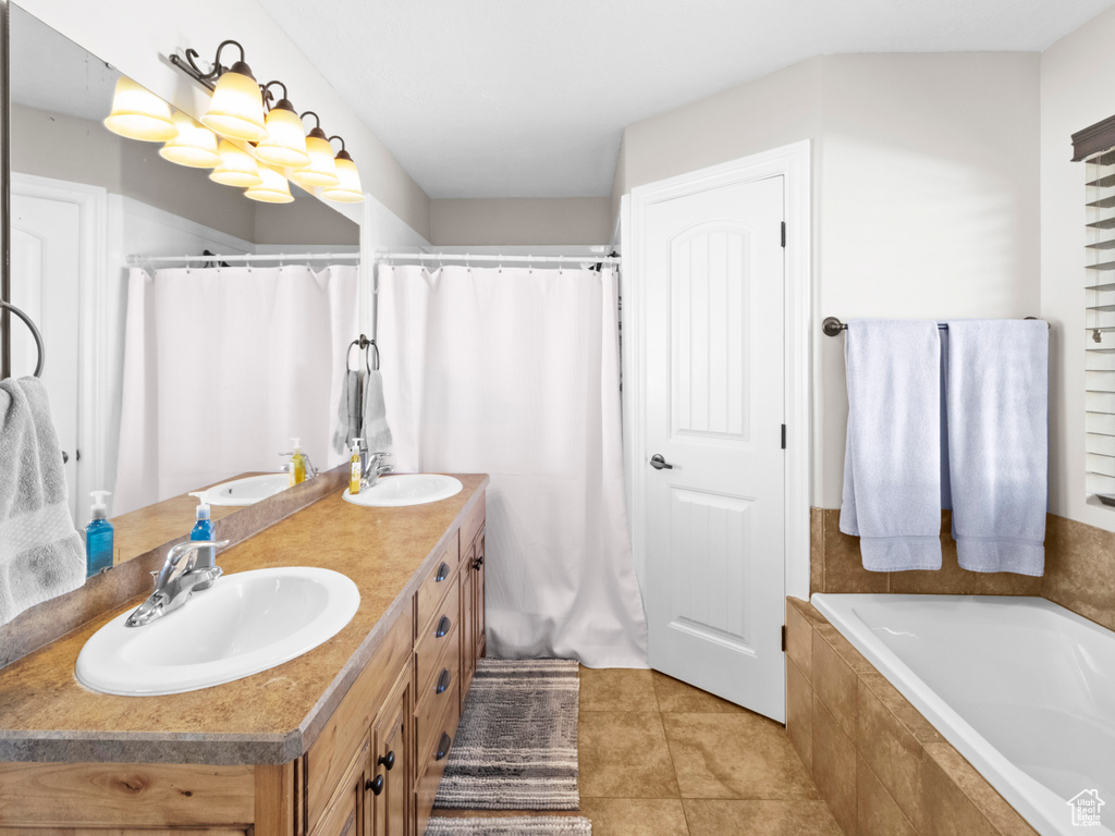 Bathroom featuring dual sinks, tile flooring, and oversized vanity