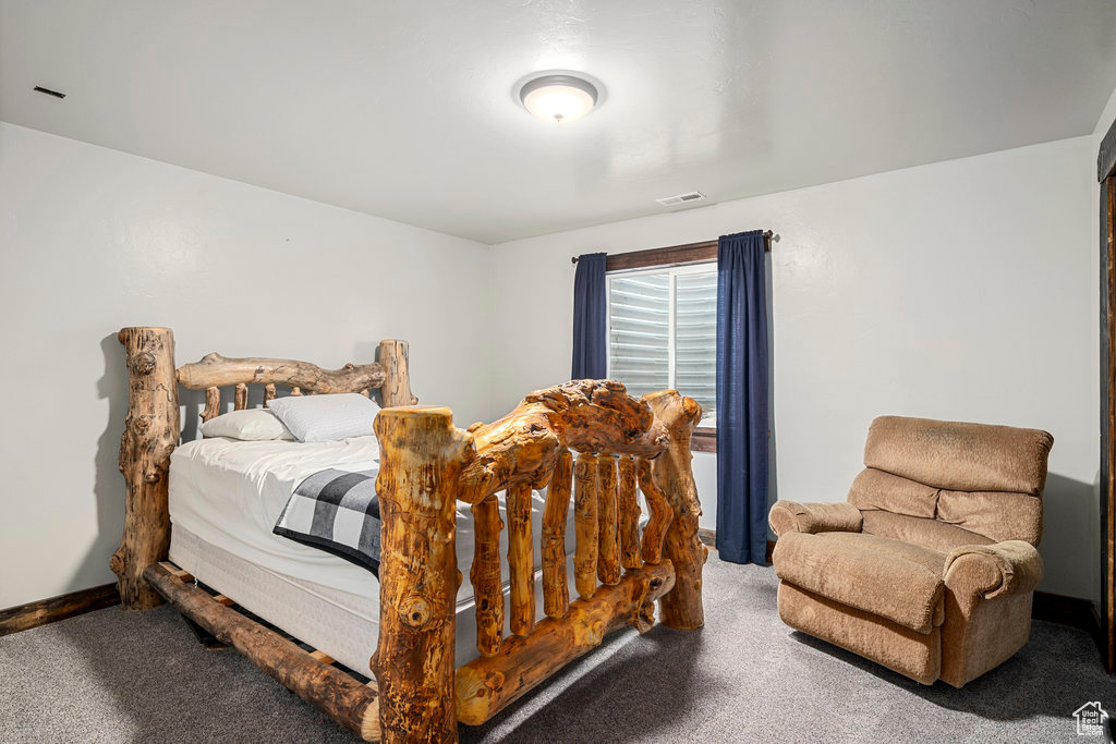 Bedroom with dark colored carpet