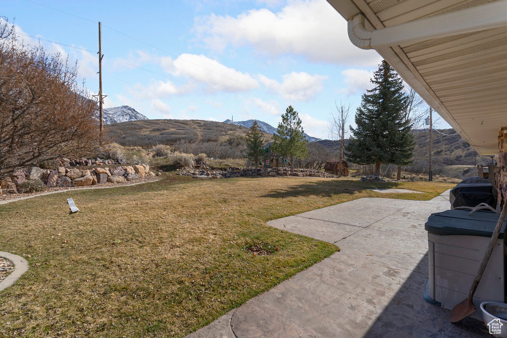 View of yard with a mountain view and a patio