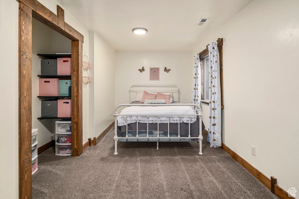 Bedroom featuring dark colored carpet