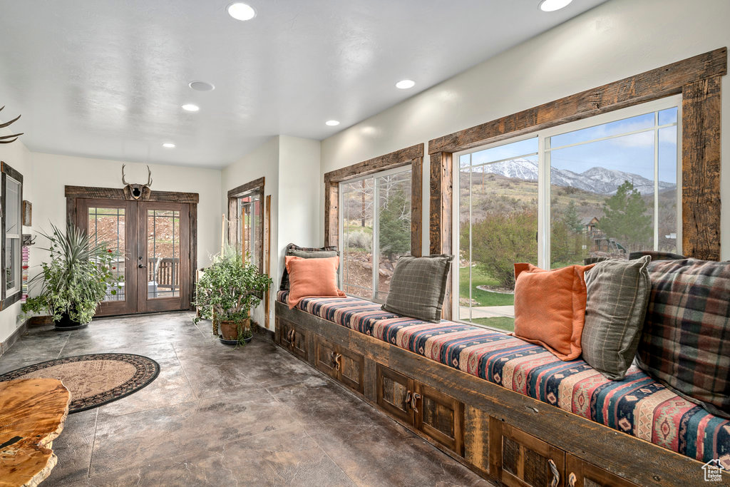 Tiled foyer featuring a mountain view, french doors, and a healthy amount of sunlight