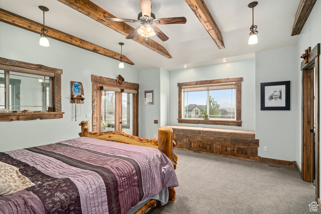 Bedroom with ceiling fan, beam ceiling, and dark carpet