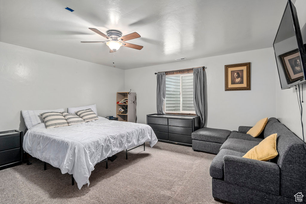 Bedroom featuring light carpet and ceiling fan