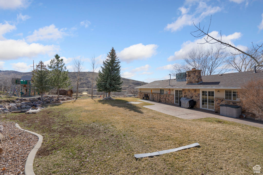 View of yard featuring a patio and a mountain view