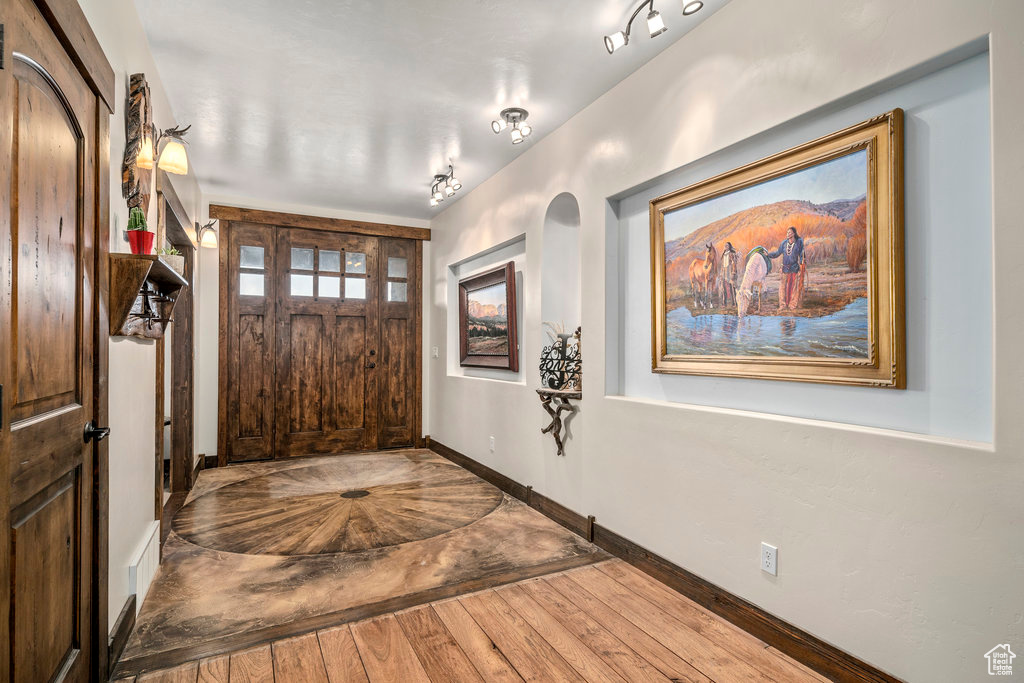 Foyer featuring track lighting and hardwood / wood-style floors