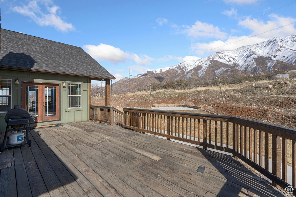 Wooden deck featuring a mountain view and french doors