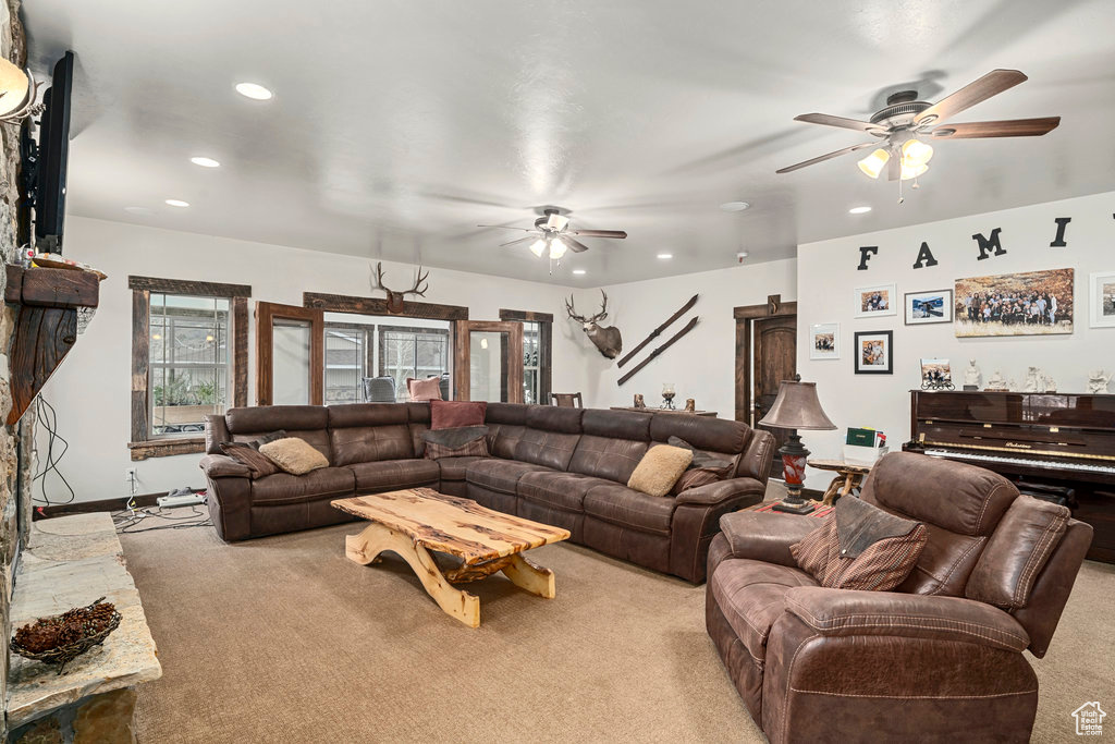 Living room with light colored carpet and ceiling fan