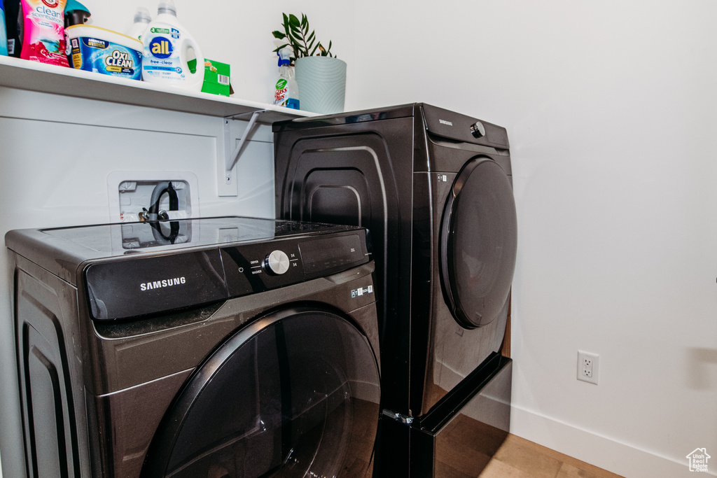 Laundry room with washer and clothes dryer and hookup for a washing machine
