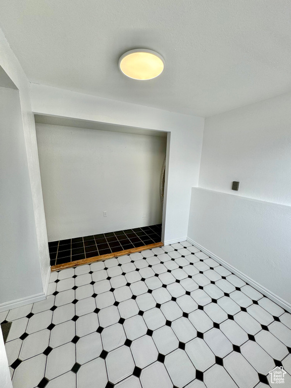 Unfurnished room with light tile flooring