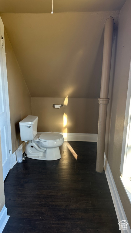 Bathroom with toilet, hardwood / wood-style flooring, and lofted ceiling