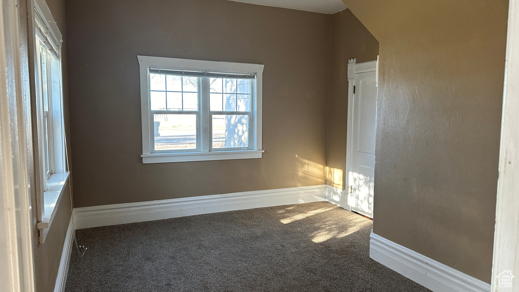 Unfurnished room with dark carpet