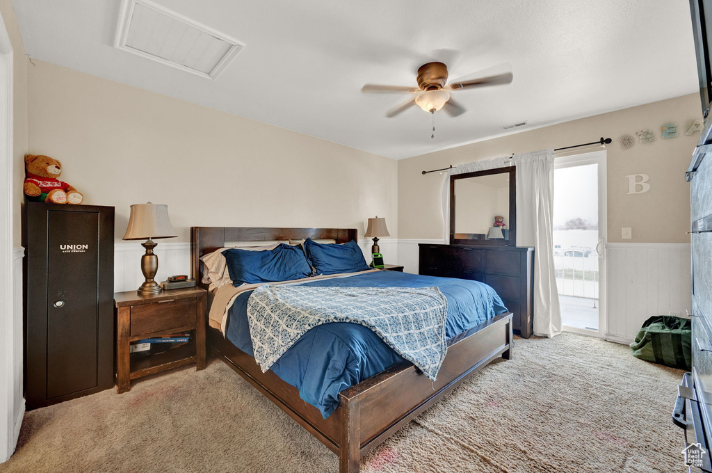 Bedroom with light colored carpet, access to exterior, and ceiling fan