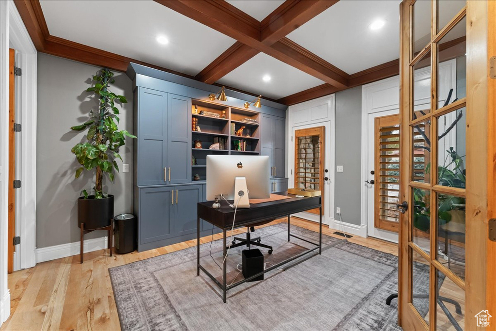 Office with coffered ceiling, light hardwood / wood-style floors, and beamed ceiling