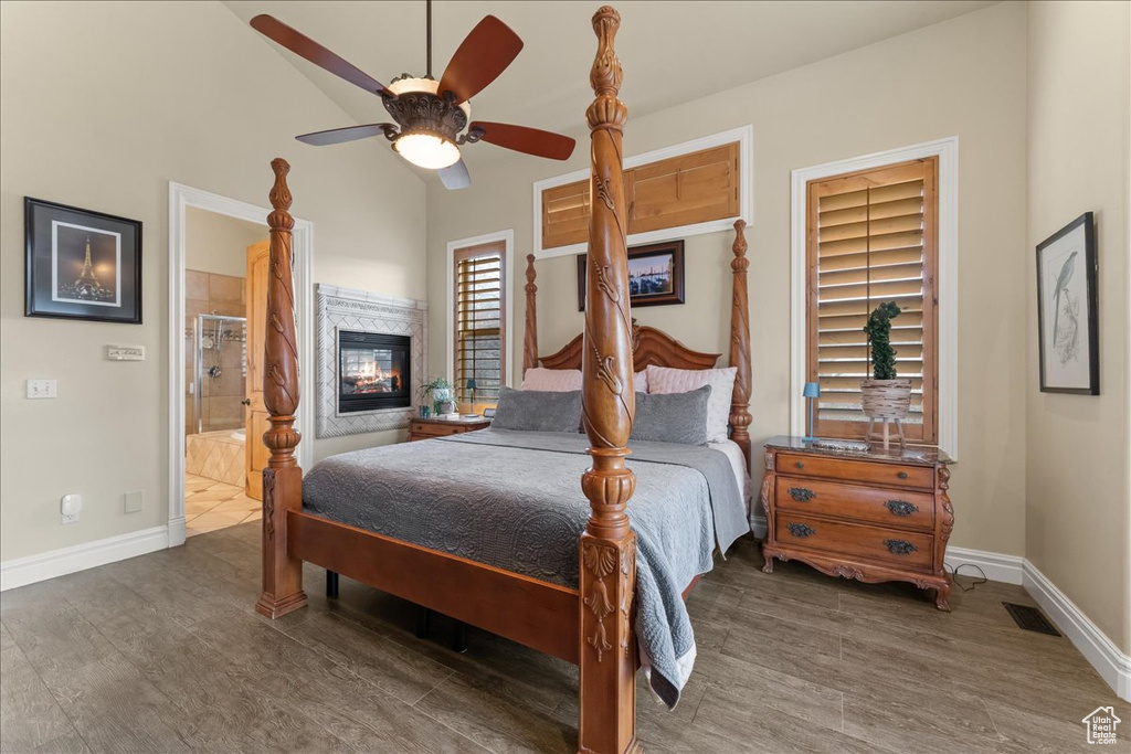 Bedroom featuring ensuite bathroom, dark hardwood / wood-style flooring, and ceiling fan