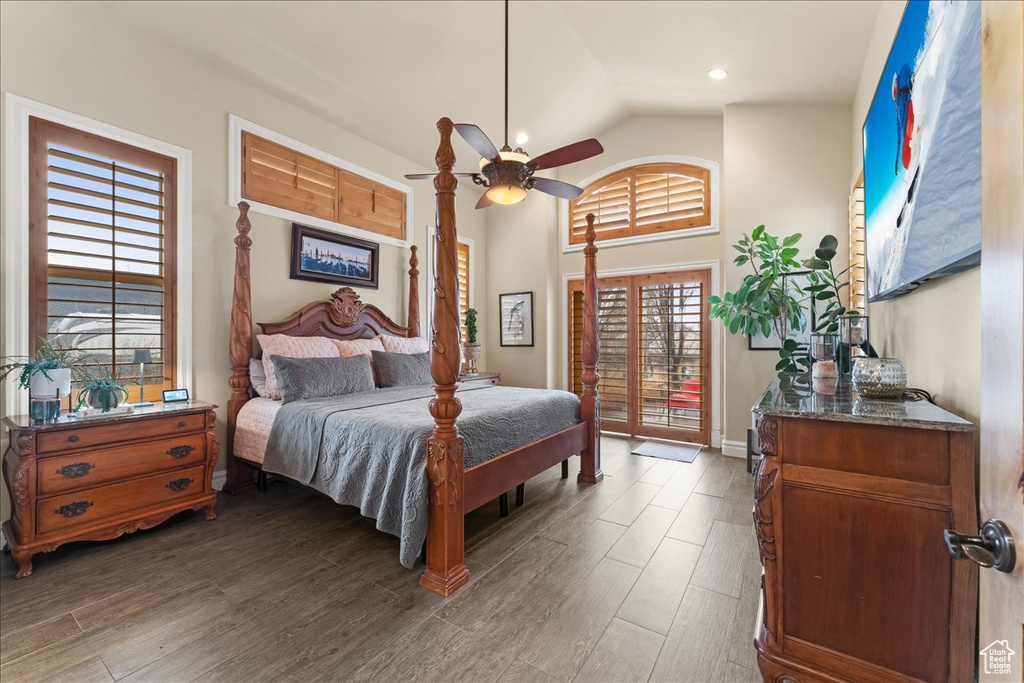 Bedroom featuring high vaulted ceiling, dark hardwood / wood-style flooring, access to exterior, and ceiling fan
