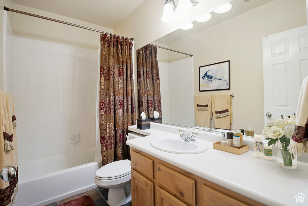 Full bathroom featuring toilet, tile flooring, shower / bath combo, and oversized vanity