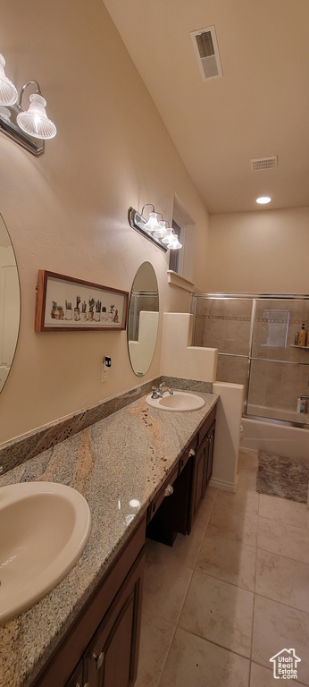Bathroom featuring tile floors and dual bowl vanity