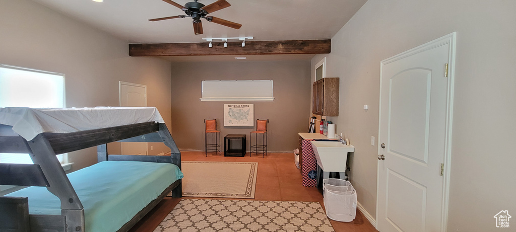 Bedroom featuring ceiling fan, hardwood / wood-style floors, and beamed ceiling