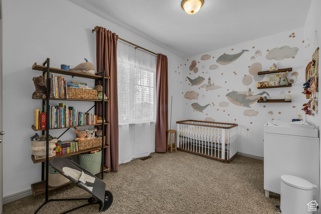 Interior space with light colored carpet and a nursery area
